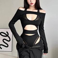 Black outfit with cut-out design worn by a model against a neutral background