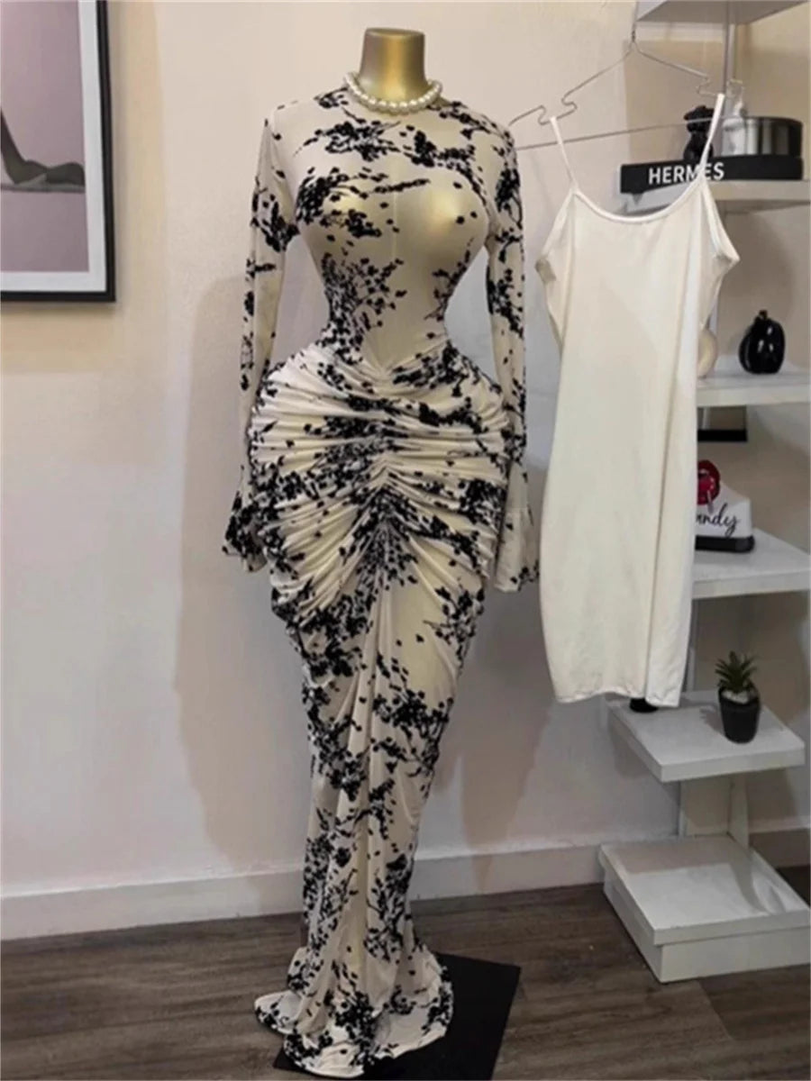 Black and white floral dress on a mannequin with a white tank top in the background.