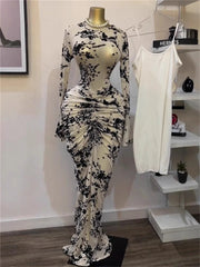 Black and white floral dress on a mannequin with a white tank top in the background.