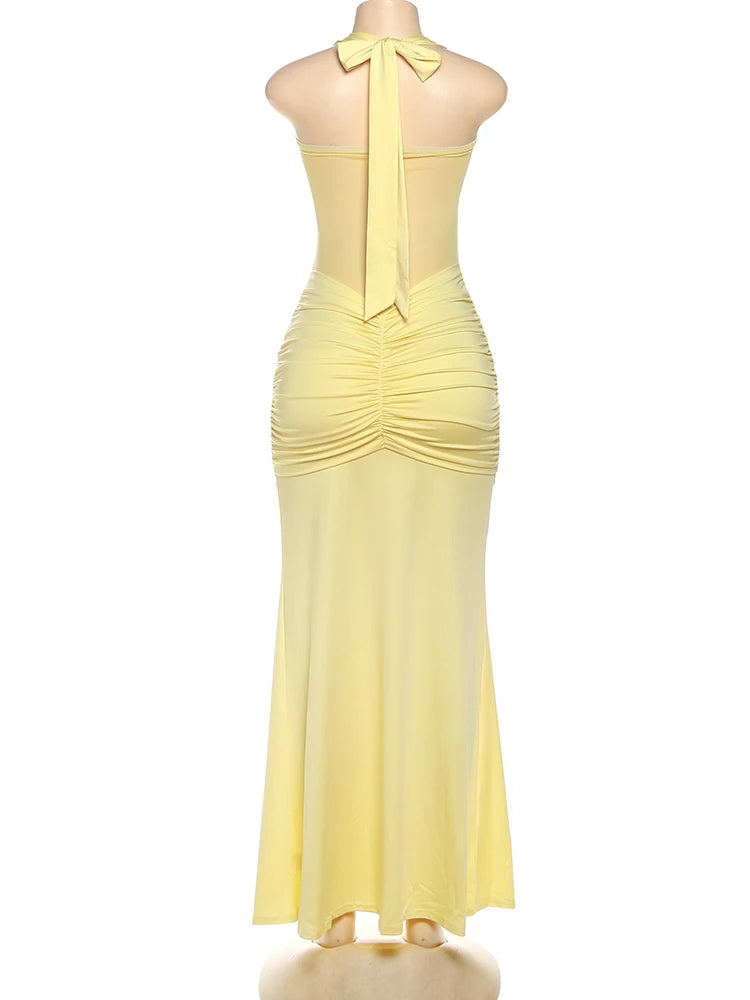 Yellow evening gown on a mannequin against a white background