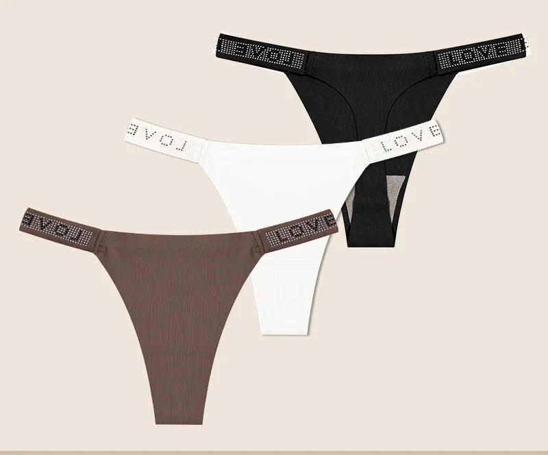 Black and brown panties with rhinestone accents on a beige background