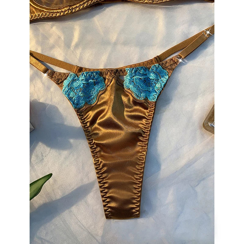 Brown bra bottom with blue floral accents on a marble surface