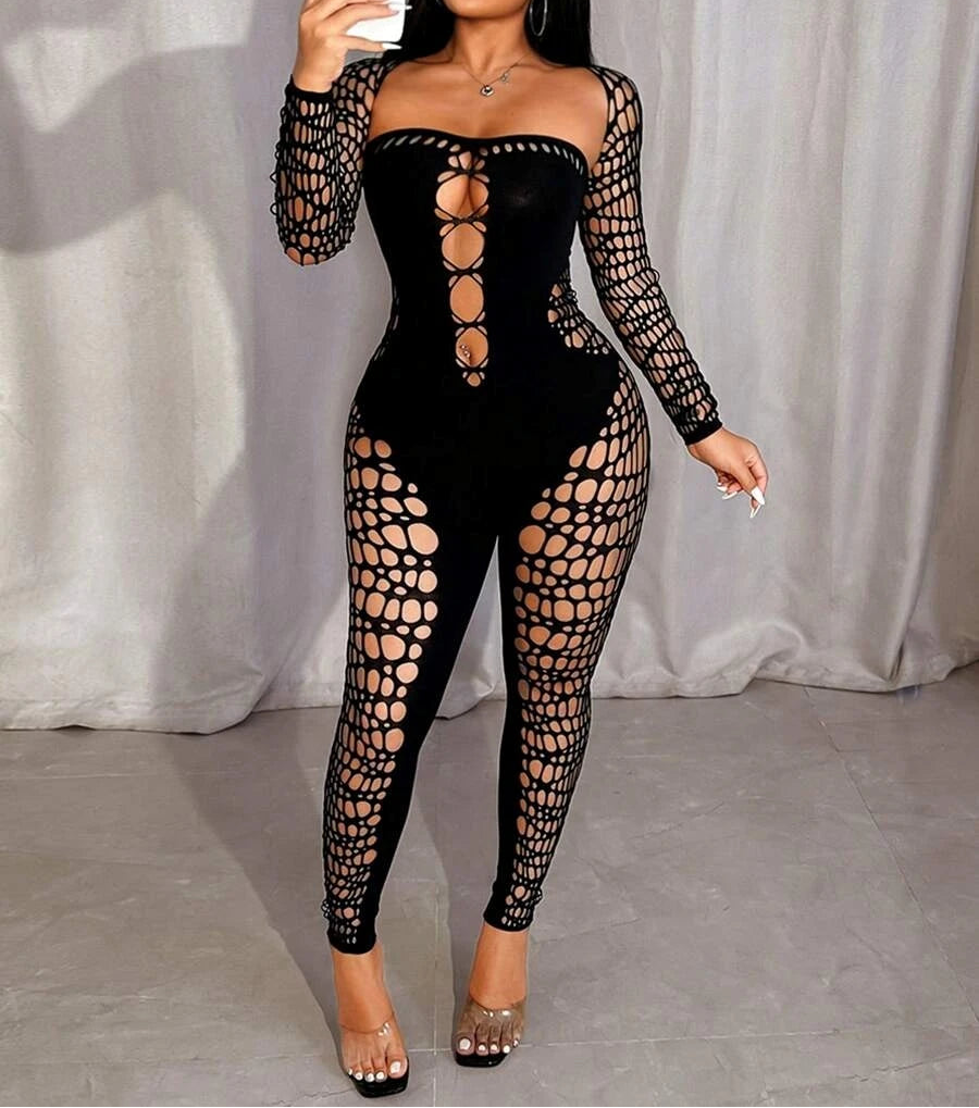Woman wearing a black lace-up bodysuit taking a mirror selfie.