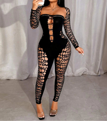 Woman wearing a black lace-up bodysuit taking a mirror selfie.