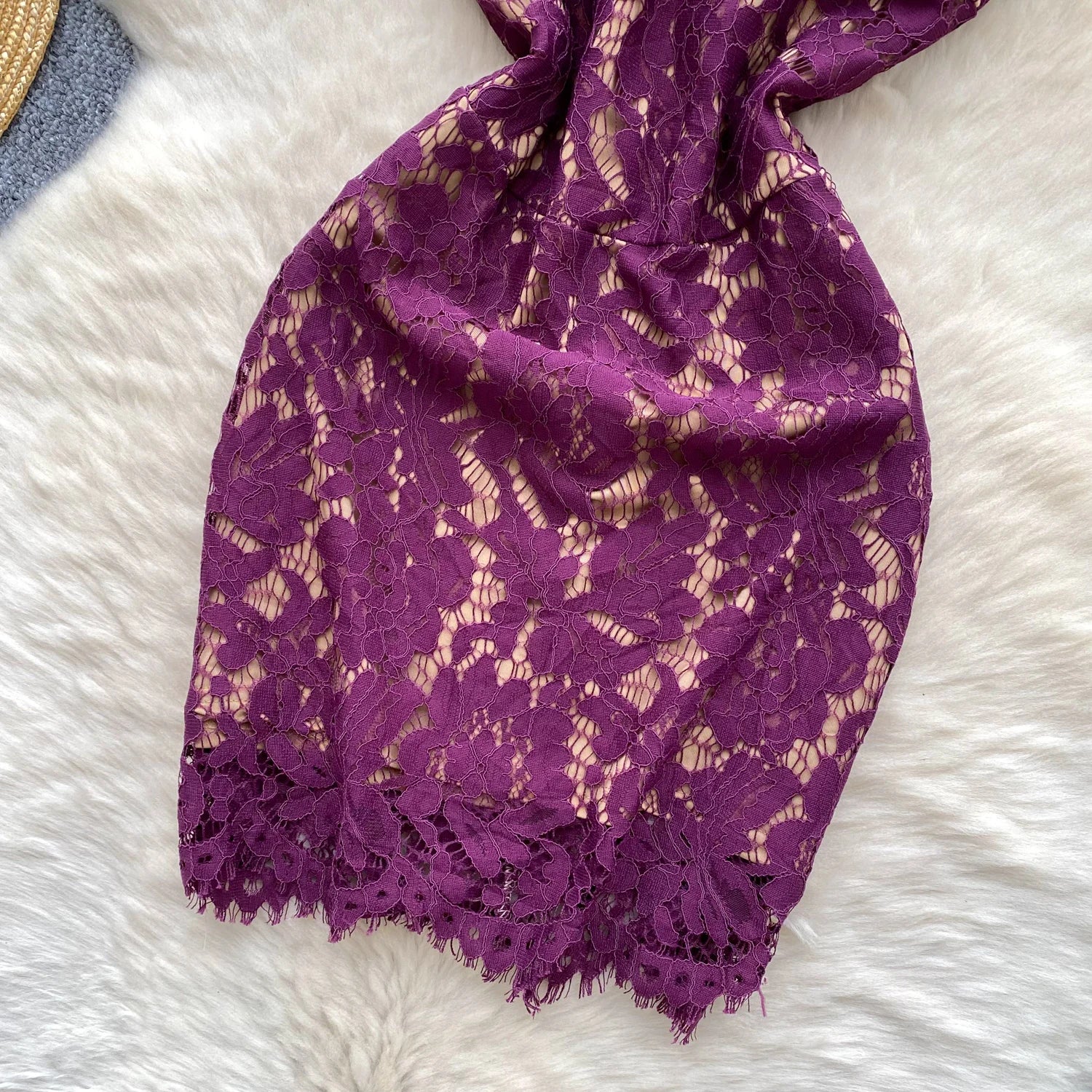 Purple lace scarf on a white fluffy surface