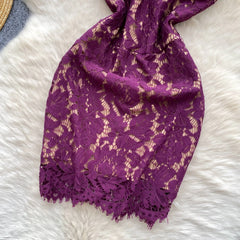 Purple lace scarf on a white fluffy surface