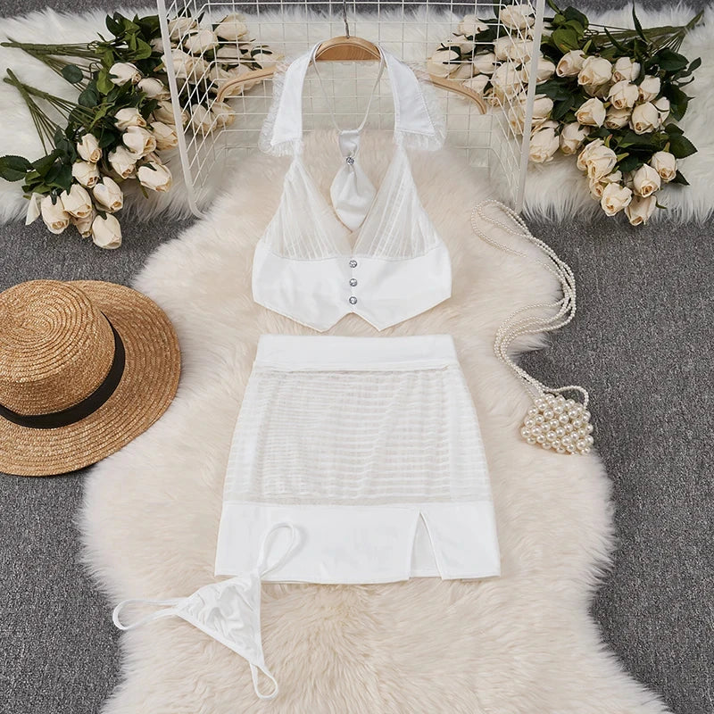 White lingerie set with a hat and handbag on a fur rug with floral decorations.