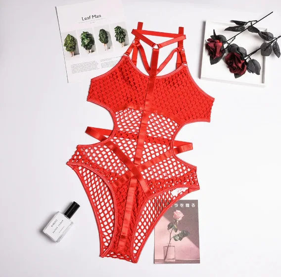 Red lace lingerie set on a light gray surface with decorative elements.