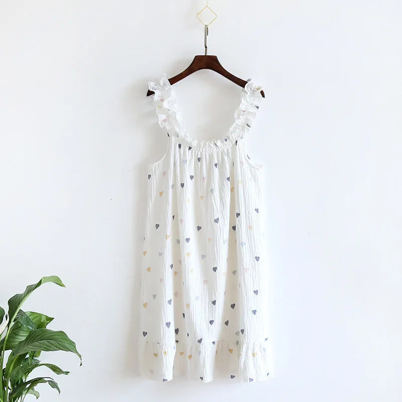 White dress with heart patterns on a hanger against a white background