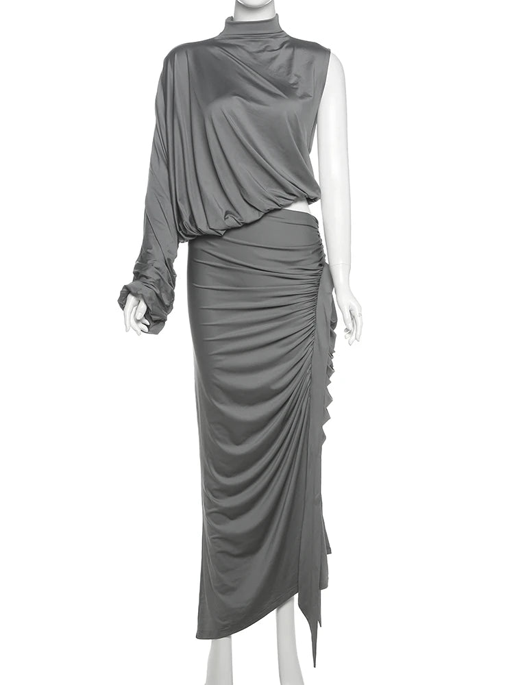 Gray draped dress on a mannequin against a white background