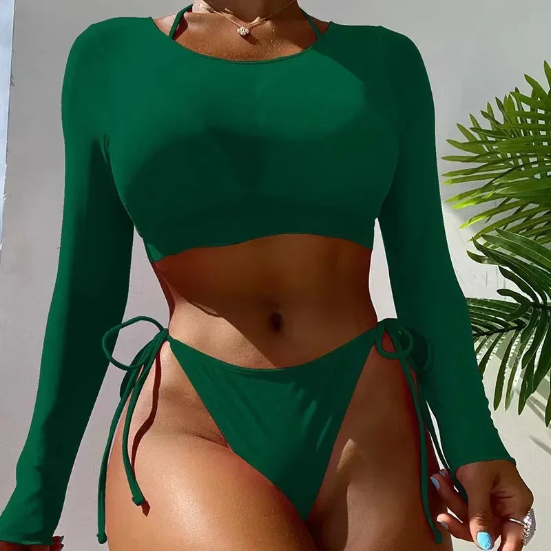 Green long-sleeve bikini set with a tropical leaf background