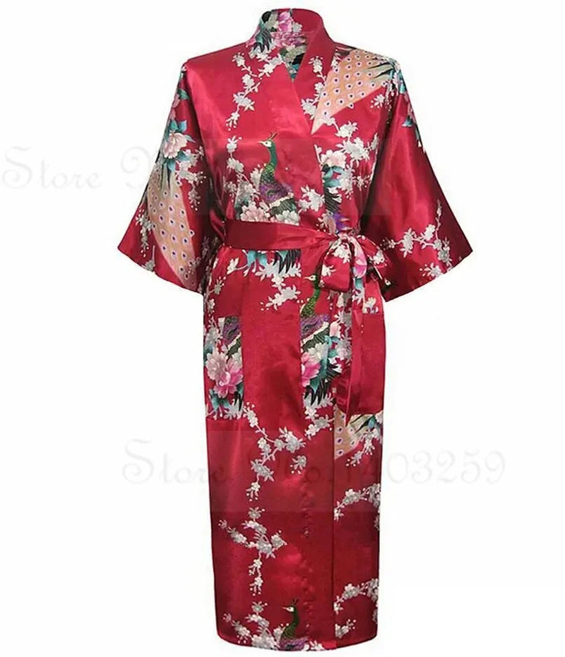 Red satin robe with floral patterns on a white background