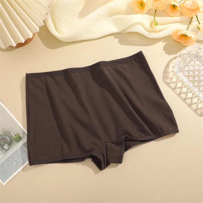 Brown boxer briefs on a beige surface with flowers in the background