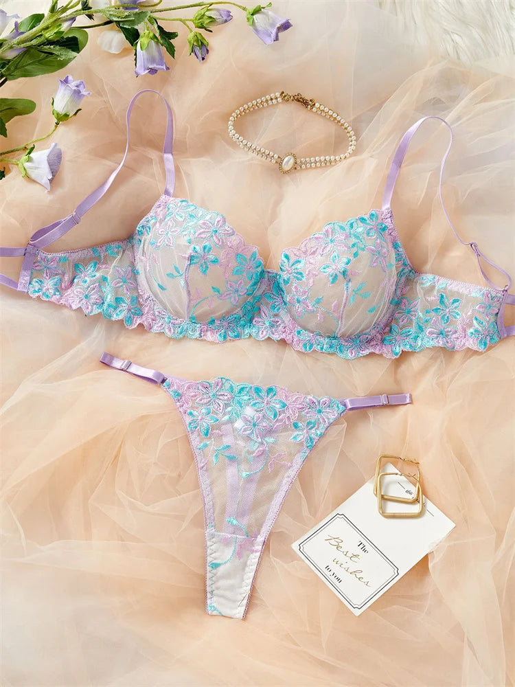Floral lingerie set with a gold bracelet on a soft fabric background