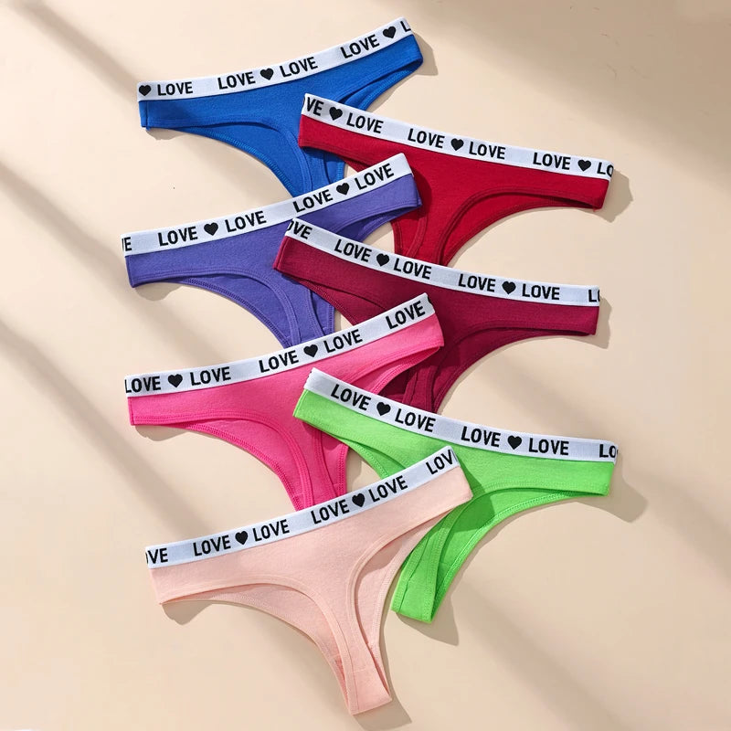 Set of women's underwear with 'LOVE' waistbands in various colors on a beige background. 1