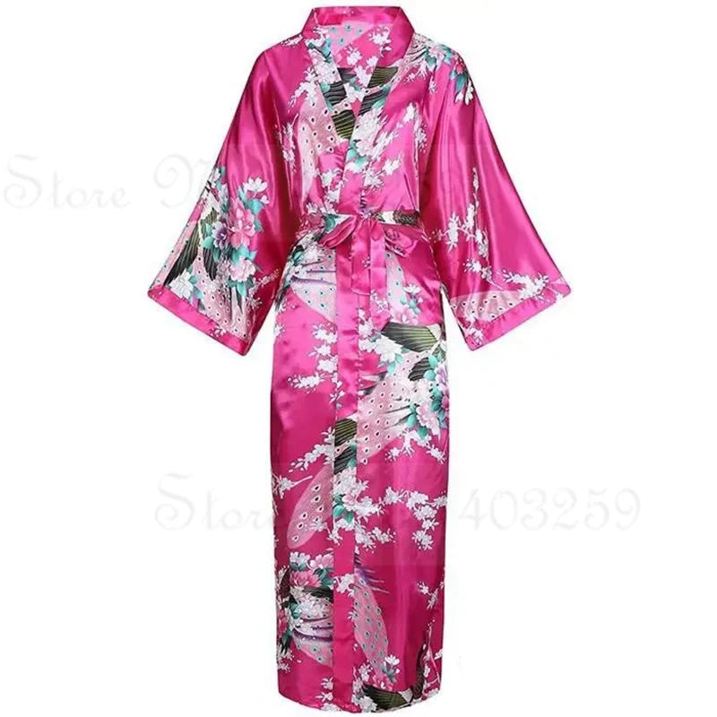 Pink satin robe with floral patterns and a pocket on a white background