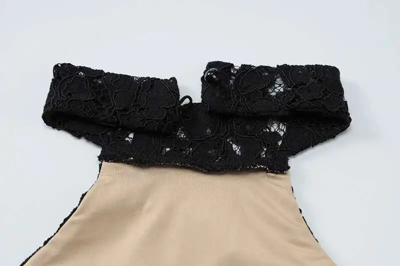 Black lace collar on a beige garment against a white background