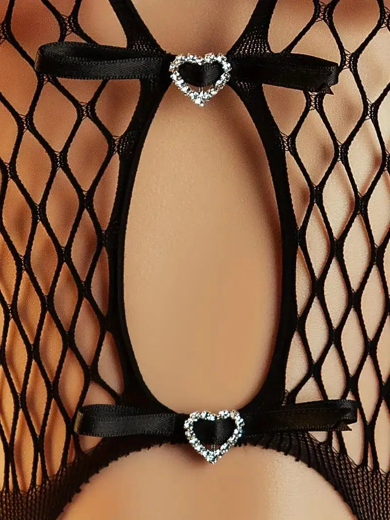 Black fishnet stockings with heart-shaped garters on a mannequin.
