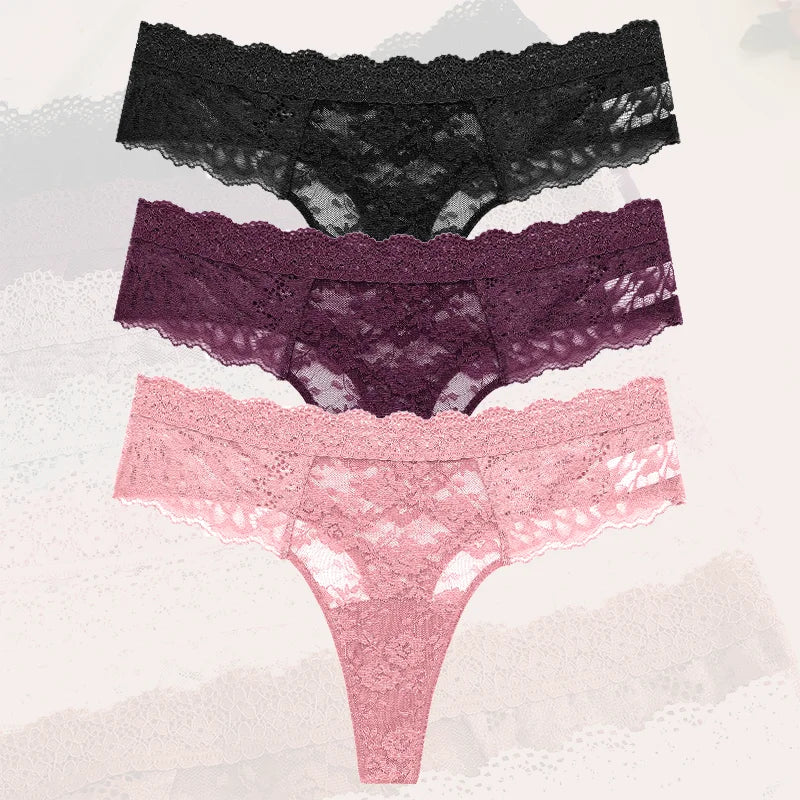 Three pairs of lace underwear in black, purple, and pink on a textured white background.