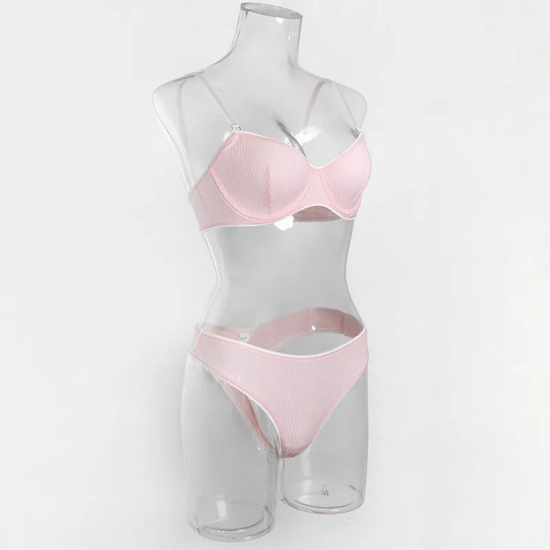 Pink bra and panties set on a mannequin against a white background