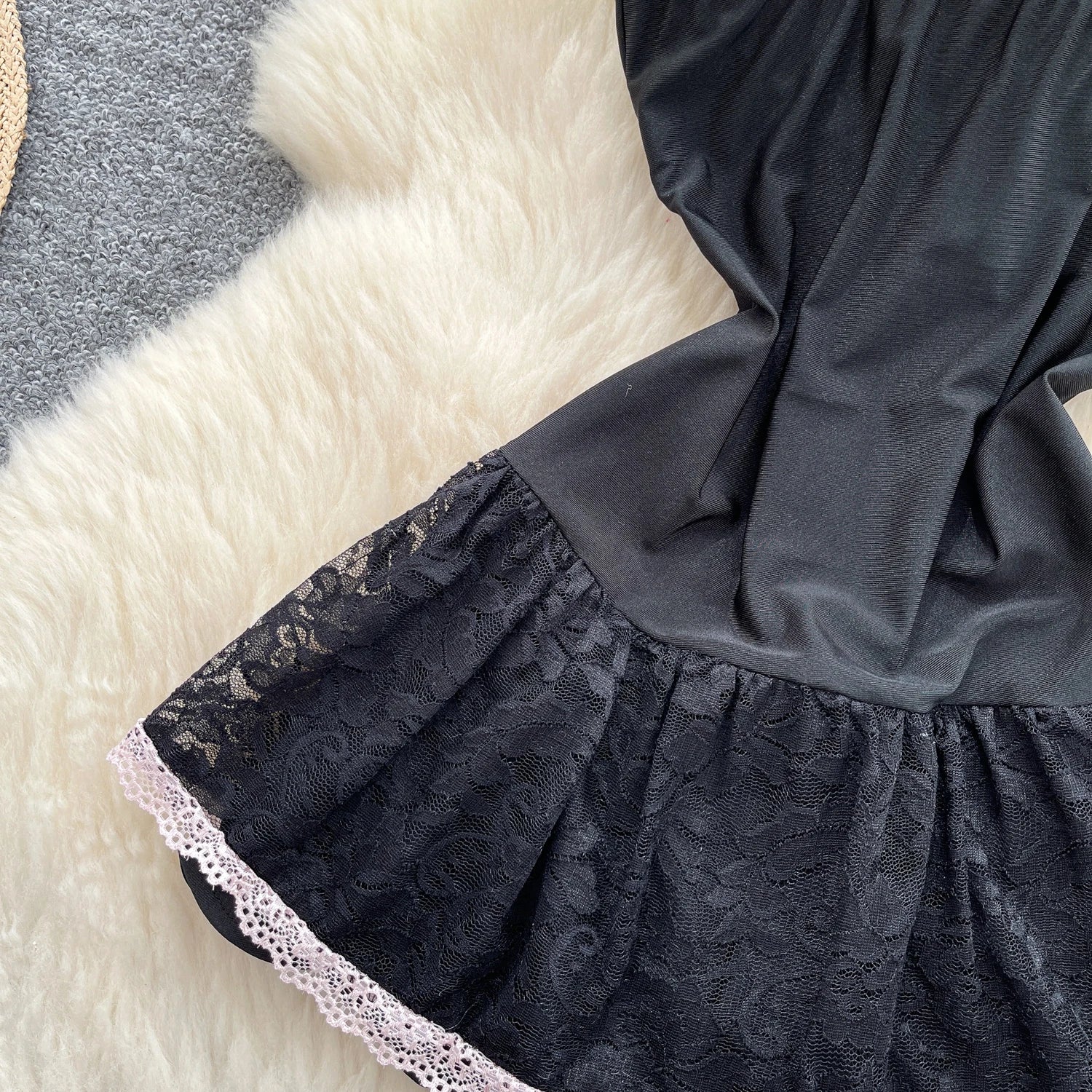 Black lace dress on a checkered fabric background