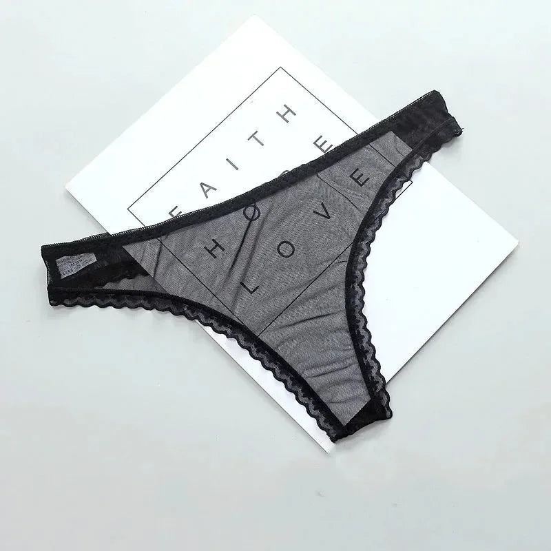 Black lace lingerie on a white surface with 'FAITH HOPE LOVE' text in the background.