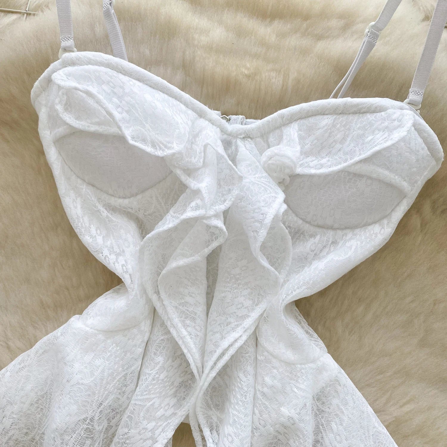 White lace lingerie set on a beige fur background