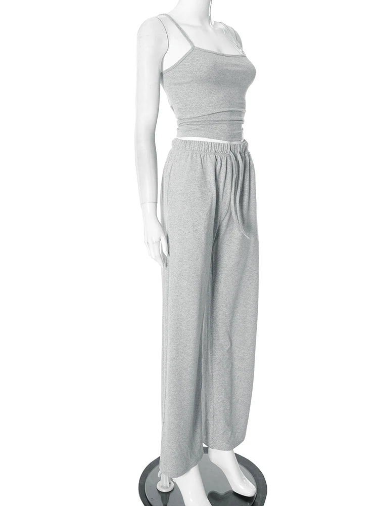 Mannequin wearing a gray one-shoulder top and wide-leg pants on a white background