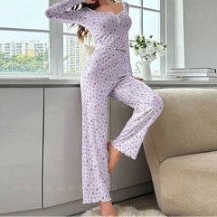 Woman wearing a floral pajama set in a room with a window and sofa.