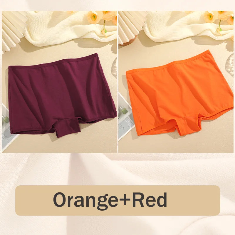 Two pairs of underwear, one purple and one orange, on a beige surface with a neutral background.