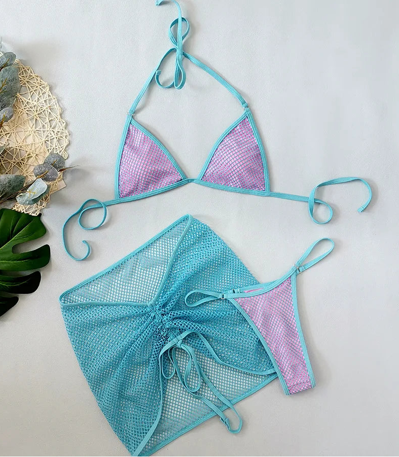 Two-piece swimsuit with turquoise top and pink mesh bottom on a light gray background.