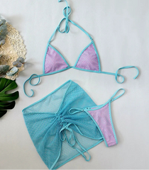 Two-piece swimsuit with turquoise top and pink mesh bottom on a light gray background.