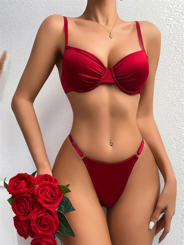 Red bikini worn by a model with red roses on a light gray background