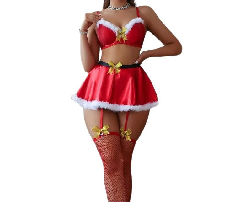 Woman wearing a red Christmas-themed lingerie set with white fur trim on a white background