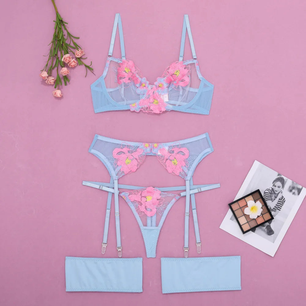 Light blue lingerie set with floral details on a pink background