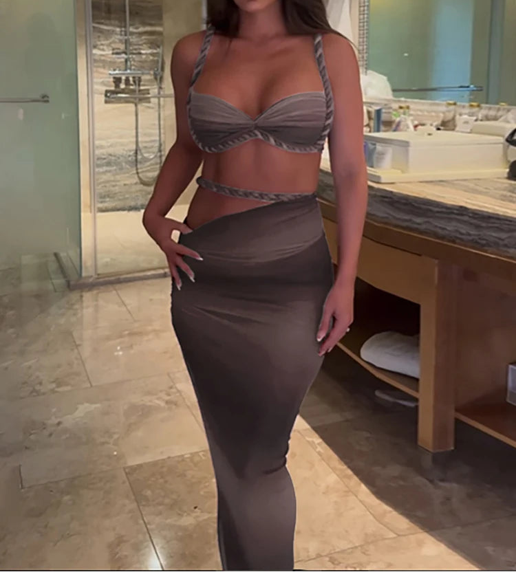 Woman in a bathroom wearing a matching bra and skirt set.