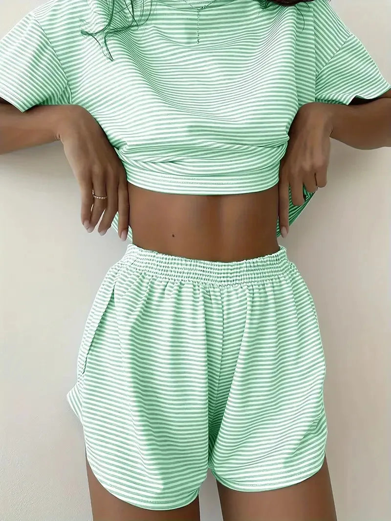 Person wearing a green and white striped outfit on a plain background
