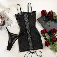 Black lace lingerie set with red roses and a magazine on a white background