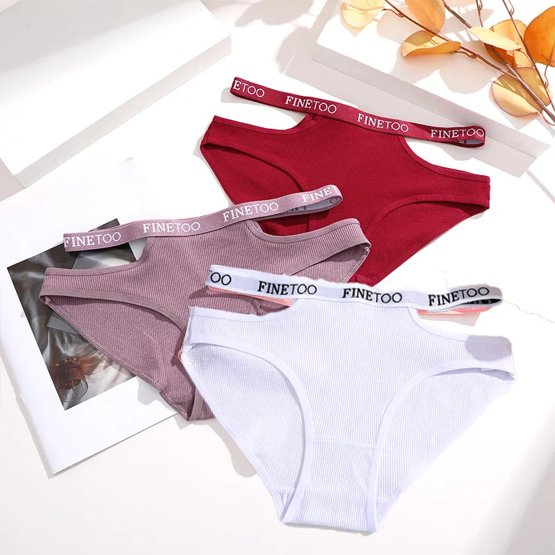 Three pairs of underwear in red, pink, and white with 'FINETOO' branding on the waistbands.