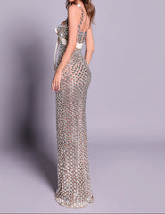 Woman wearing a sparkling evening gown on a gray background