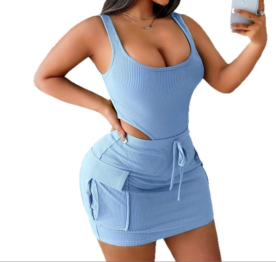 Woman wearing a light blue ribbed two-piece set taking a selfie.