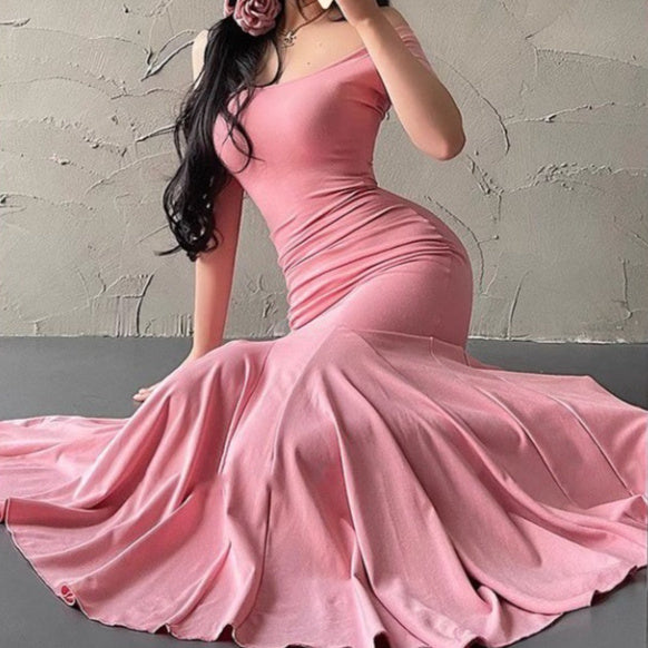 Pink evening gown with a mermaid silhouette on a neutral background