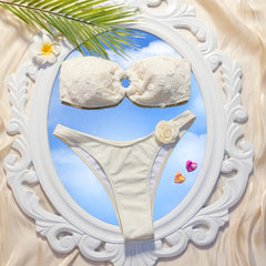 White bikini set with a decorative frame and tropical elements on a beige background