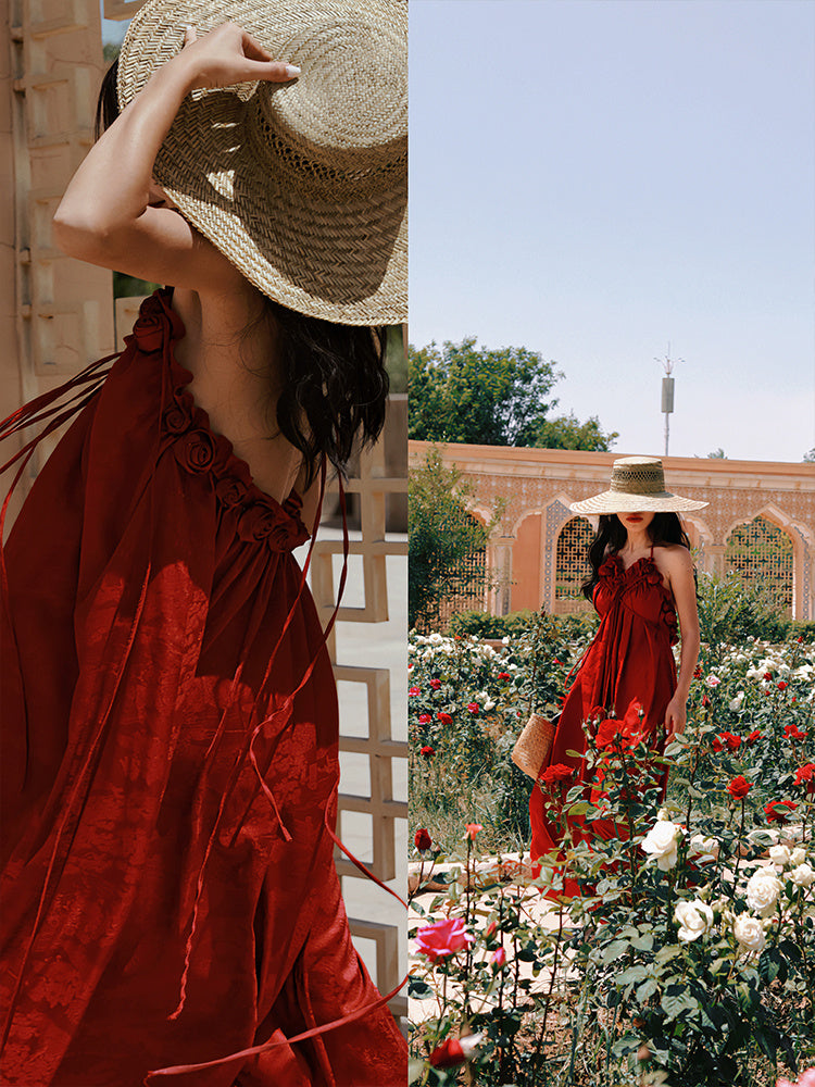Woman in a red dress and straw hat in a garden setting